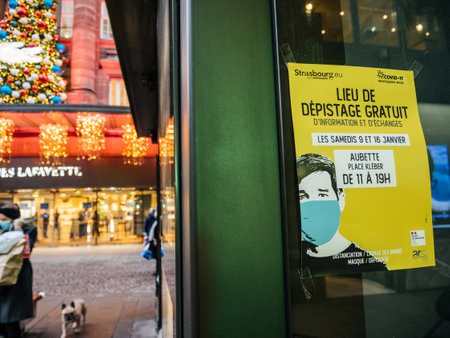 Strasbourg, France - Jan 7, 2021: Advertising board of free COVID-19 test in central Place Kleber square and Galeries Lafayette department store in the backgroundのeditorial素材