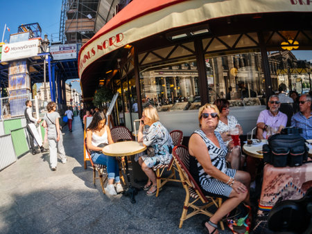 Paris, France - May 20, 2018: Ultra wide-angle view of French street with cafe Terminus nord near Gare du Nord train station with full outdoor terrace people eating - pre-CoVIDのeditorial素材