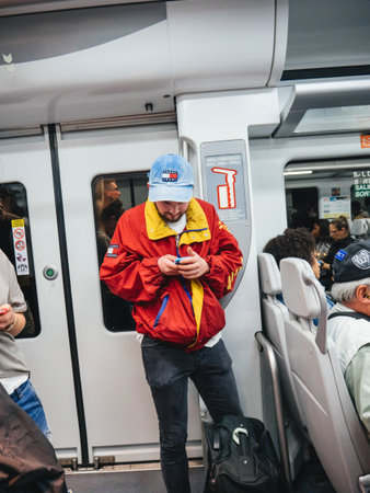 Lisbon, Portugal - May 30 2, 2018: Large crowd of people commuting inside Lisbon metro tube train - man using smartphone touching his screen - textingのeditorial素材