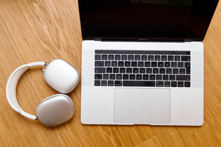Paris, France - Jan 7, 2020: Placed next new MacBook Pro M1 laptop the best Apple Computers AirPods Max over-ear headphonesのeditorial素材