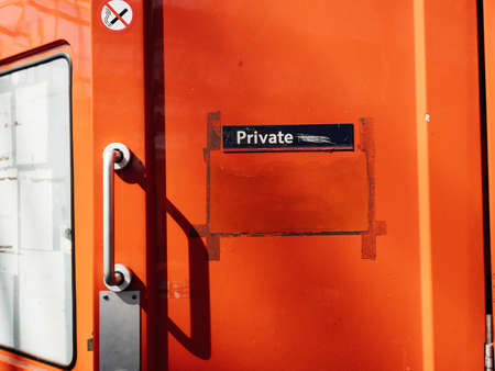 Private inscription on the door of a british train wagon - vivid red color and silver handleの写真素材