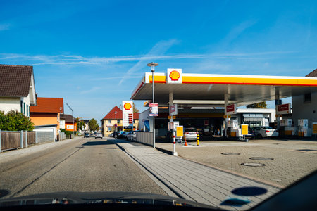 Schiltach, Germany - Oct 7, 2018: POV view from the car over the large long street in German village with Shell gas station on the right - clear blue skyのeditorial素材
