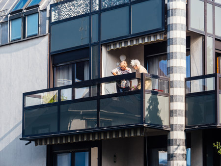 Paris, France -Oct 9, 2018: Two senior women on the large balcony breathing fresh air in French architecture apartment buildingのeditorial素材