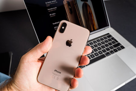 Paris, France - Sep 25, 2018: POV male hand holding latest Apple Computers iPhone Max smartphone...