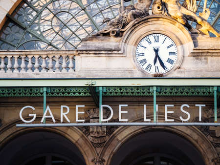 Paris, France - Oct 13, 2018: Parisian morning with Gare de lEst signage and Boded clock on the iconic facade early in the morningのeditorial素材