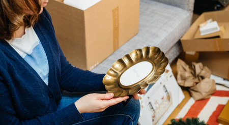Paris, France - Jan 22, 2021: Side view of woman unboxing new Zara Home product - beautiful vintage...