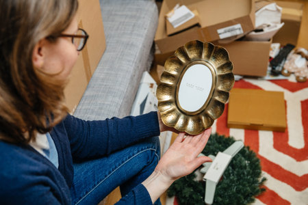 Paris, France - Jan 22, 2021: POV woman unboxing new Zara Home product - beautiful vintage forged...