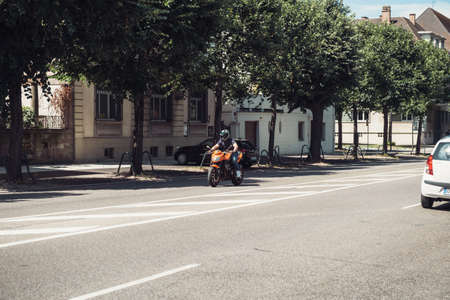 Strasbourg, France - July 29, 2017: Motorcyclist on orange Kawasaki sport motorcycle driving fast on French streetのeditorial素材