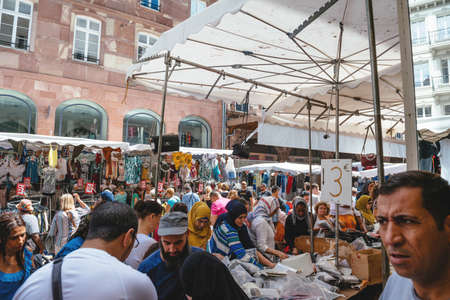 Strasbourg, France - July 29, 2017: Large crowd of people walking on the street of Strasbourg during the Grande Braderie - street fair annual sale event - clothes and diverse object on saleのeditorial素材