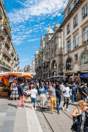 Strasbourg, France - July 29, 2017: Large crowd of people walking on the tramway line street Strasbourg during the Grande Braderie - street fair annual sale event - clothes and diverse object on saleのeditorial素材