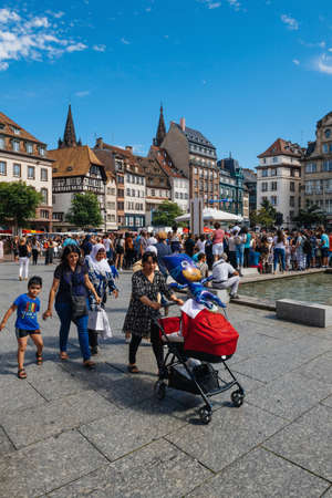 Strasbourg, France - July 29, 2017: Failies, locals and visitors people pedestrians walking in central PLace Kleber square with Notre-Dame cathedral in background on a warm summer dayのeditorial素材