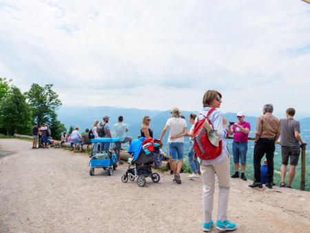 Baden-Baden, Germany - Jul 7, 2019: Large group of people and fashionable woman on top of Merkur Mountain admiring the Baden wurttemberg panorama on a summer dayのeditorial素材