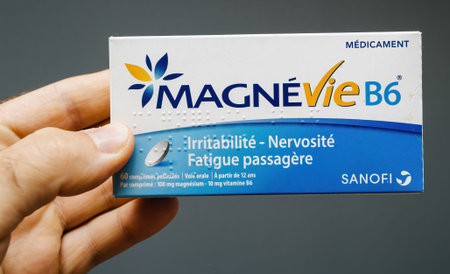 Paris, France - Jun 21, 2020: POV male hand holding package with new Magnevie b6 vitamins...