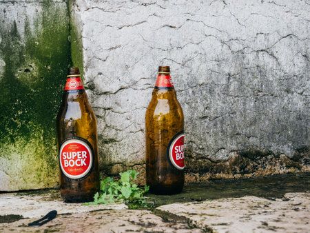 Lisbon, Portugal - Feb 9, 2018: Two empty bottles of Super Bock Sabor Autentico beer on the groundのeditorial素材