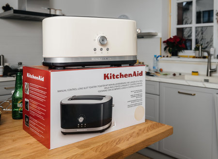 Paris, France - Feb 1, 2021: Unboxed hero object holding new KitchenAid 5KMT4116EAC toaster luxury...