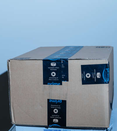 PAris, France- Jan 23, 2021: Close-up of well pretected by scotch tape Amazon Prime cardboard box parcel - the on-line retailer giant was founded by Jeff Bezosのeditorial素材