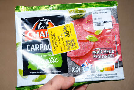 Paris, France - Feb 13, 2021: POV male hand holding Charal Carpaccio delicious meat with special minus 30 percent discount due to soon to arrive best beforeのeditorial素材