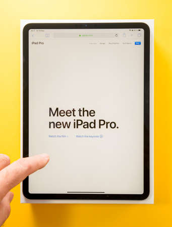 Paris, France - Feb 4, 2021: POV male hand holding looking at the new Apple Computers iPad Pro with text on the screen Meet the new ipad Proのeditorial素材