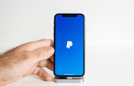 Paris, France - Oct 2, 2018: POV male hand holding new latest Apple Computers iPhone 11 12 pro with...