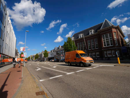 The Netherlands - Aug 19, 2018: Brand-new IVECO van from the Dutch post driving to deliver the parcels lettersのeditorial素材