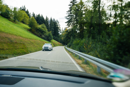 Switzerland - Sep 22, 2018: Driver POV at car view at the front driving Mercedes-Benz SUV electric...