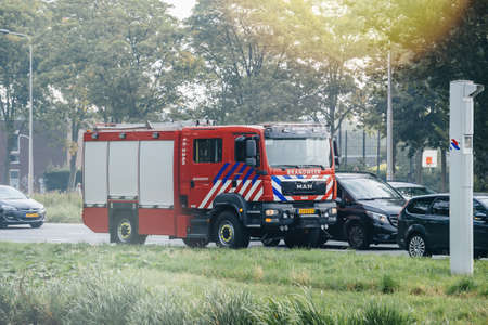 Haarlem, Netherlands - Aug 29, 2019: Large new red MAN firefighter Brandweer truck on the Haarlem street avenueのeditorial素材