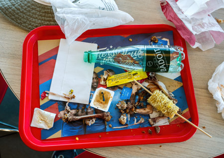 Overhead view of food leftovers at KFC fast food restaurant with Badoit