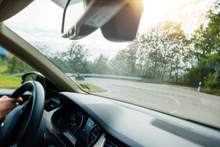 Entering difficult corner on the rural highway with 35 km mph per hour speed on the digital display dashboard speedometerの写真素材