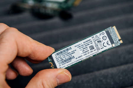 POV male hand holding new SK Hynix NVME fast M2 disk driveのeditorial素材