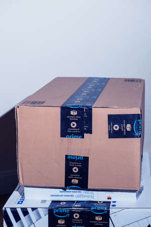 Close-up of well pretected by scotch tape Amazon Prime cardboard box parcel - the on-line retailer giant was founded by Jeff Bezosのeditorial素材