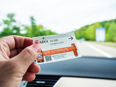 Male hand holding inside car ticket of Toll Road operated by Area