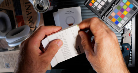Man opens the pack with new AirTag