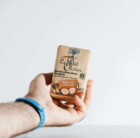 male hand holding soap bar manufactured by French Le petit Olivierのeditorial素材