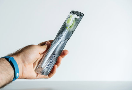 male hand holding new toothbrush manufactured by Dr Bestのeditorial素材