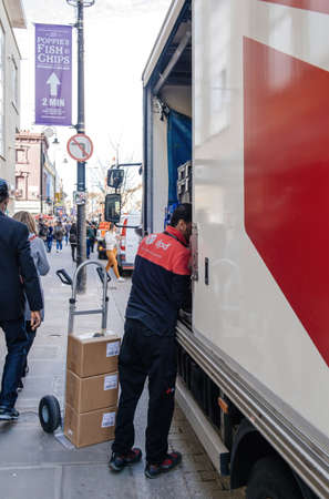 Rear view of DPD parcel delivery workerのeditorial素材
