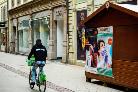 Rear view of lonley man on bike near the testing chalet market stall with BioSynex logotypeのeditorial素材