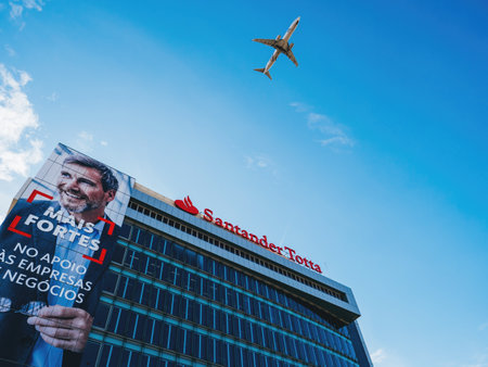 KLM plane flying above the Santander Totta bank headquarter building in Lisbonのeditorial素材