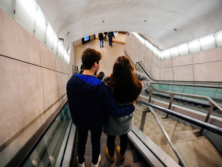 Rear view of young couple descending on escalator to change the train platform in Nice-Villeのeditorial素材