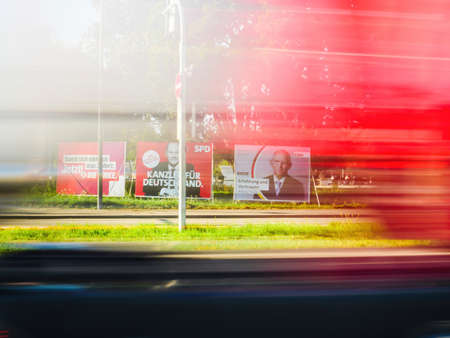 argo trailer truck silhouette drives near large election posters with the chancellor candidates of SPD with Olaf Scholz, CDU with Armin Laschet and Bundnis 90 Die Grunenのeditorial素材