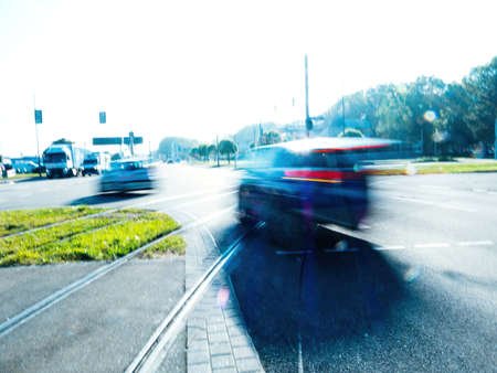blur motion trails of car driving over tramway laneの写真素材
