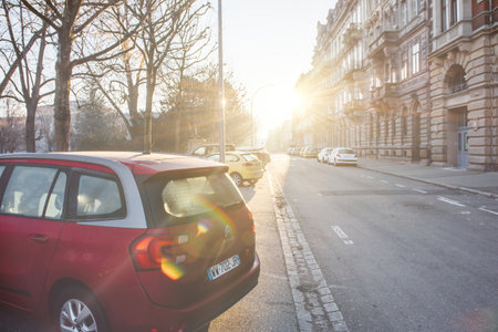 Sunlight flare over French street with beautiful large haussmannian buildingのeditorial素材