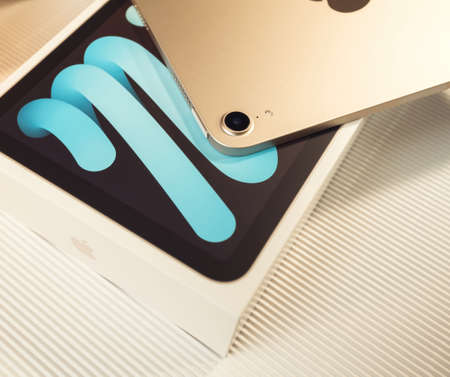 Unboxing of new sixth-generation Apple Computers iPad Mini tablet - open plastic film tapeのeditorial素材