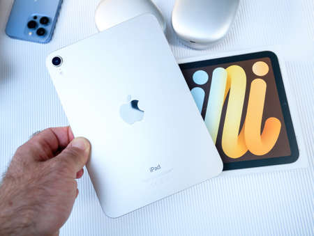 POV male hand holding after unboxing the new iPad Mini 6th tablet with the finger sensor security enclaveのeditorial素材