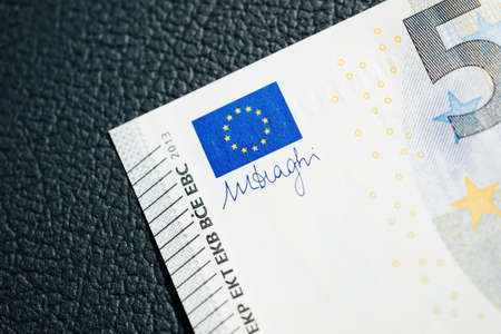 Close-up macro shot of new 5 euro currency bank note with EU flag and Mario Draghi signatureの写真素材