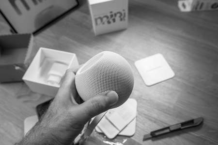 lack and white image Man unboxing the latest Apple Computers HomePod Miniのeditorial素材