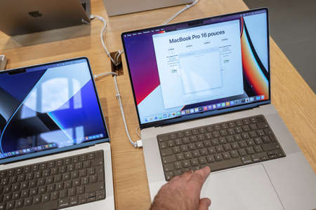 Male hand testing new Apple Computers MacBook book pro 16 inch laptop featuring an all-new design with more ports, no Touch Bar, MagSafe, M1 Pro and M1 Max chips, a mini-LED display with camera notchのeditorial素材