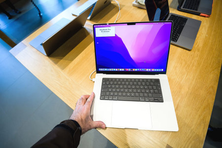 Male hand looking at the new Apple MacBook book pro 16 inch laptop