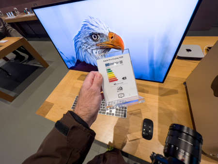 male hand looking at the energy label of the new Apple Pro Display XDR Displayのeditorial素材