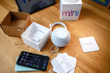 Man unboxing unpacking latest HomePod mini by Apple Computers