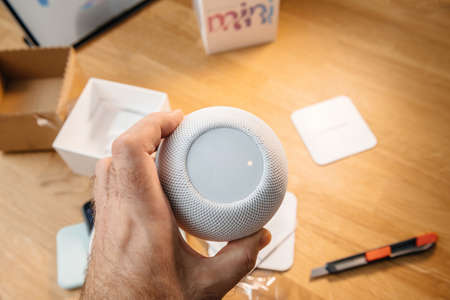 Man unboxing the latest Apple Computers HomePod Mini smart speakerのeditorial素材